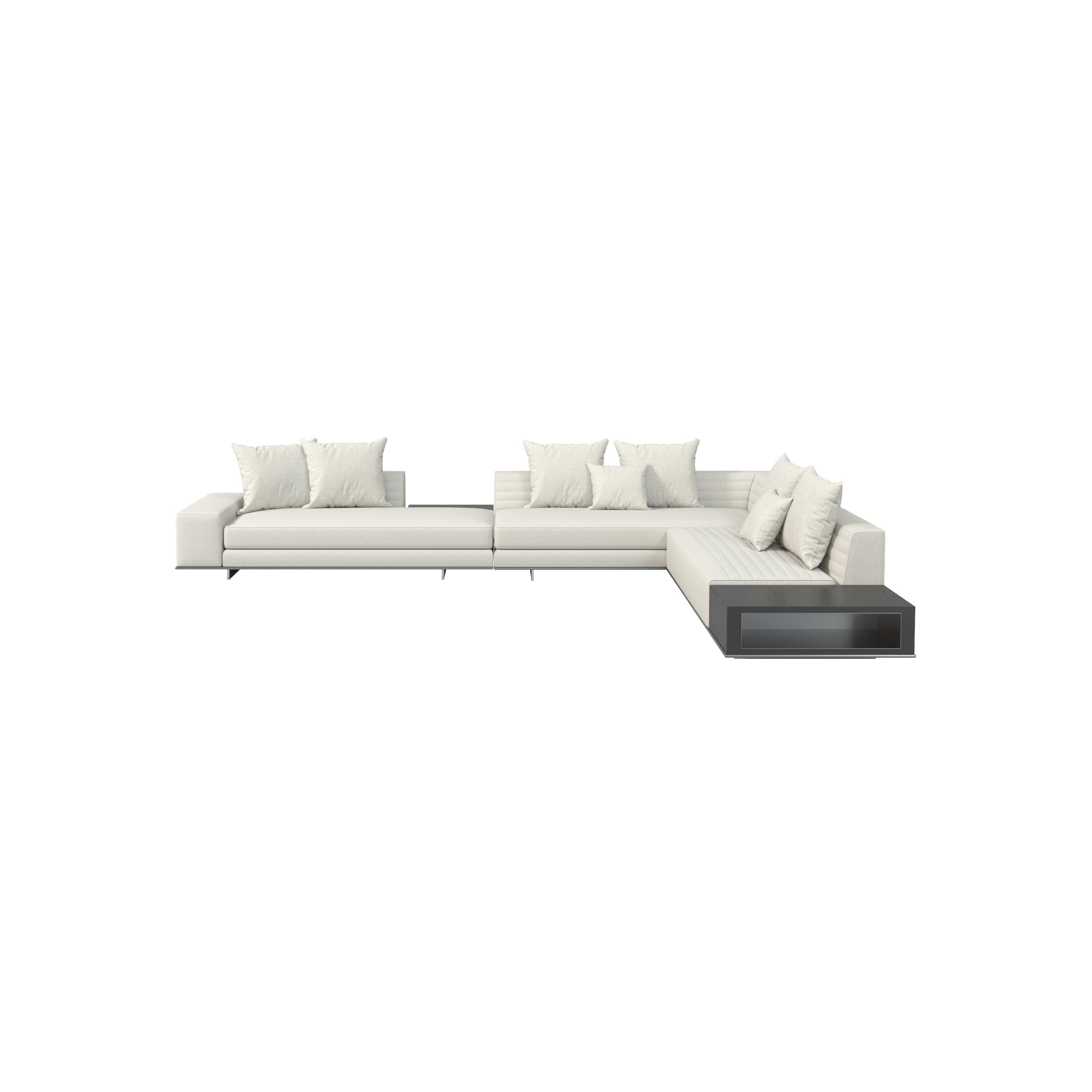 Modern sectional sofa with off-white fabric upholstery and dark gray base unit, featuring multiple cushions, low-profile legs, and a corner chaise with integrated shelf; designed for seating and casual lounging. Category: furniture/sofas