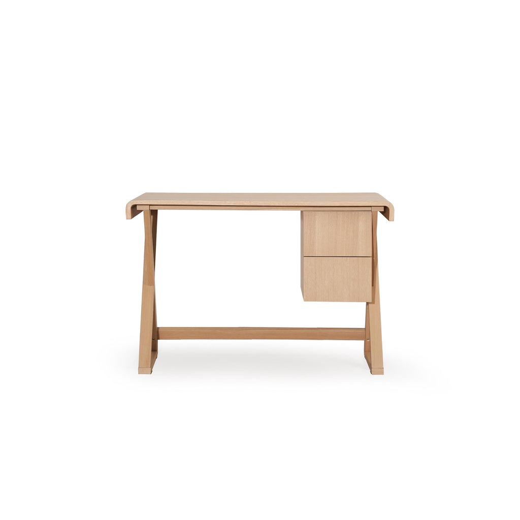 A wooden desk with a light-toned finish, featuring a rectangular top, two drawers on the right, and angled legs connected by a horizontal support beam. The surface shows visible wood grain. Intended for work or study use. Category: furniture/desks