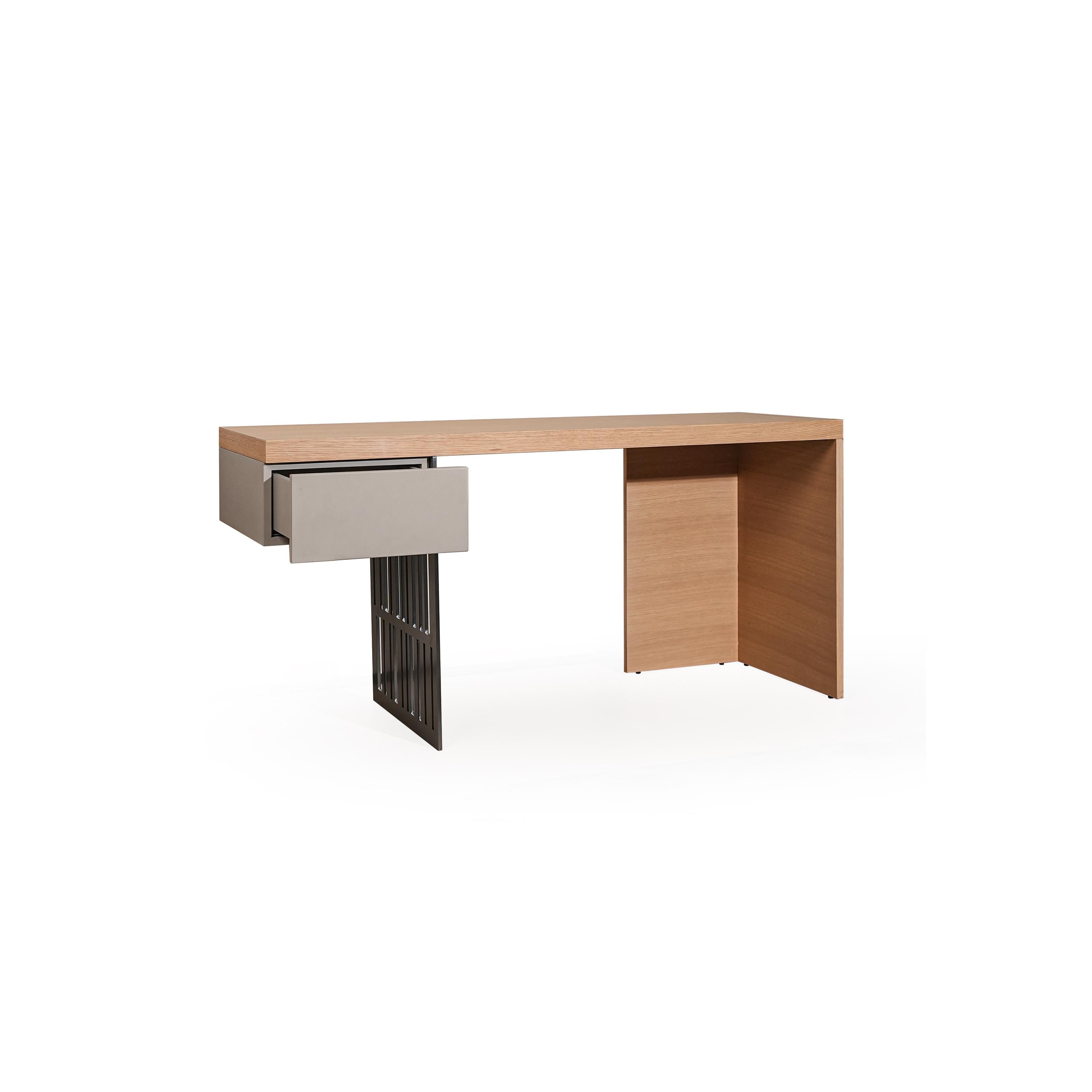 Modern desk with light wood top and gray drawer front, supported by a black metal leg and a wooden pedestal base; features a recessed storage compartment on the right side; intended for workspace use; Category: furniture/desks